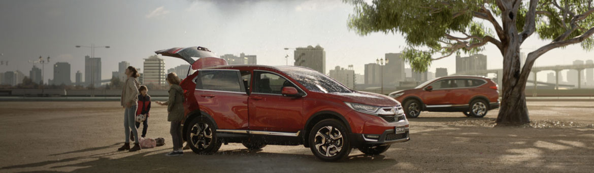 Honda Jazz hatch in Attract Yellow parked on a city street.