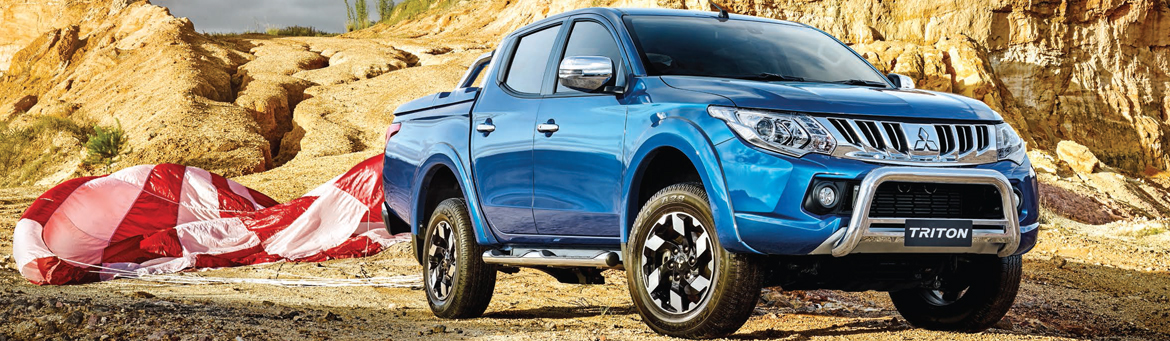Mitsubishi Triton Exceed 4x4 dual cab utility in impulse blue parked in a quarry.