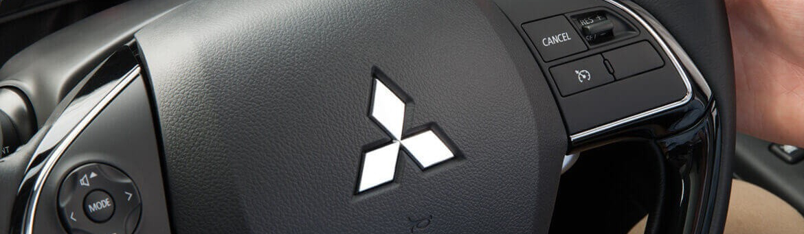 Close up of multi-function controls on a Mitsubishi steering wheel.