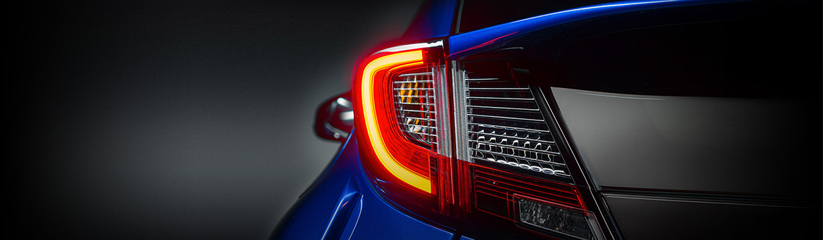 Close up of the rear LED tail lights on a Honda Civic hatch in brilliant sporty blue.