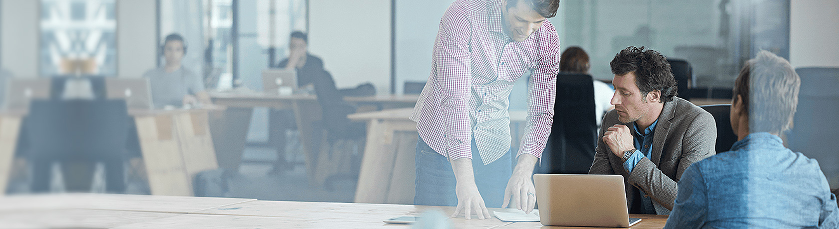 Two men discussing car finance in a Renault showroom.