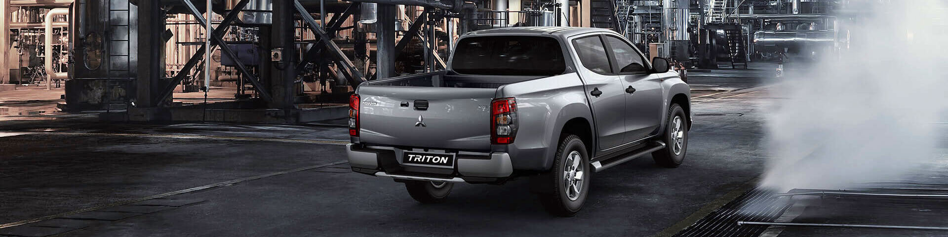 Rear view of a Mitsubishi Triton dual cab ute in silver.