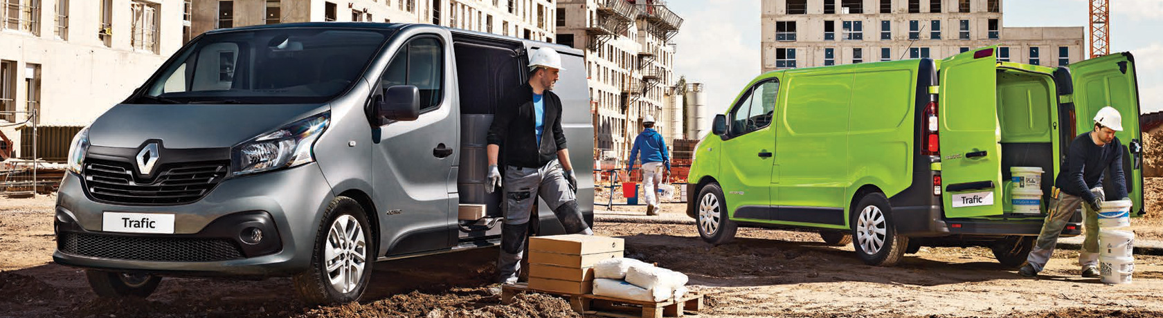 Renault Trafic vans in bamboo green and mercury grey hard at work on the building site.